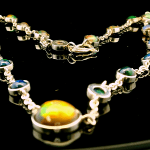 This stunning Ethiopian opal necklace is a masterpiece of elegance and sophistication. Each opal is carefully set in a delicate silver chain, creating a mesmerizing play of colors